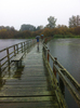 cruzando ponte de madeira na chuva